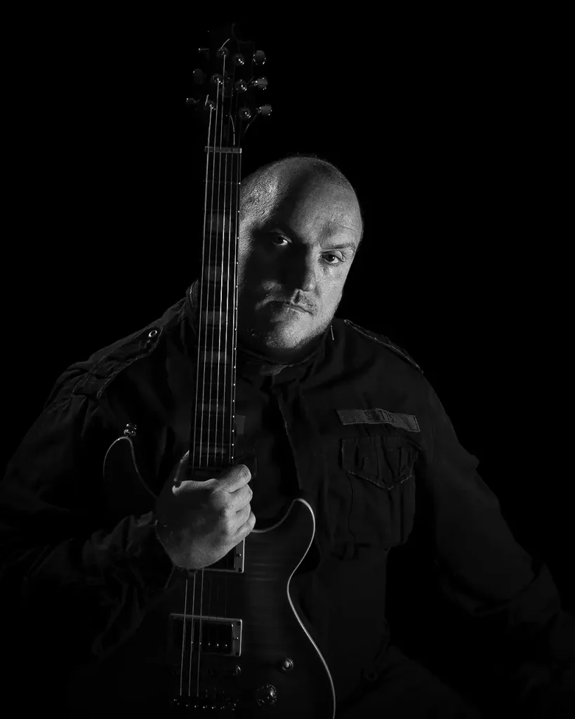 Self-portrait of me holding an electric guitar.