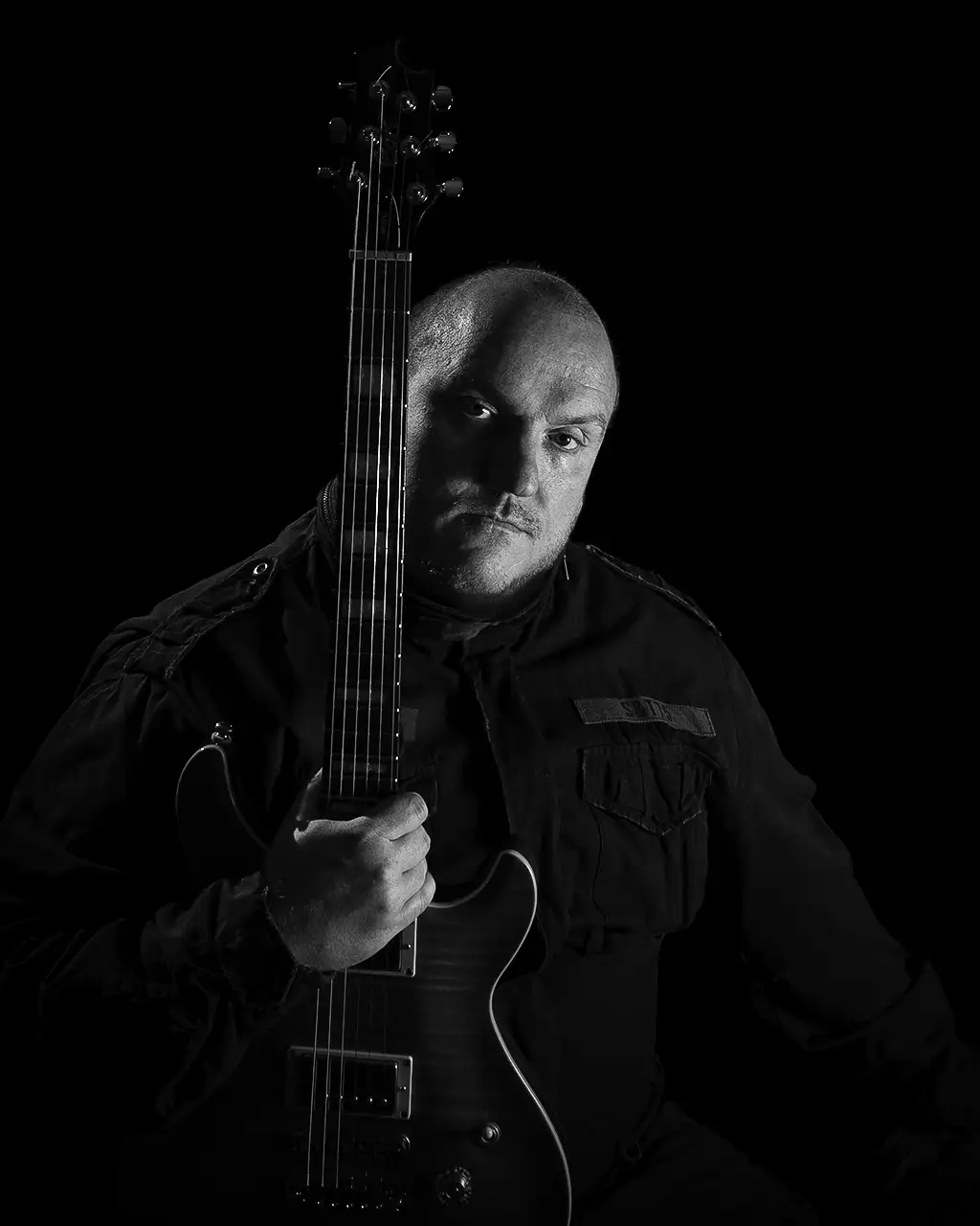 Self-portrait of me holding an electric guitar.